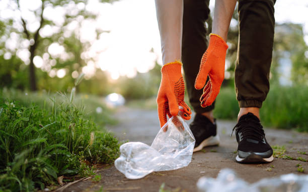 istock Men hand collects plastic trash for cleaning in the park. 1243696127