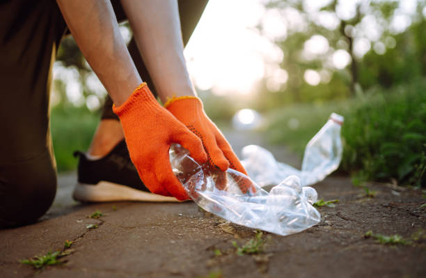 istock Men hand collects plastic trash for cleaning in the park. 1243696129