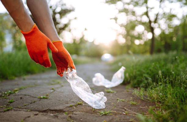 istock Men hand collects plastic trash for cleaning in the park. 1243696130