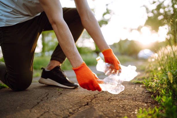 istock Men hand collects plastic trash for cleaning in the park. 1243696144