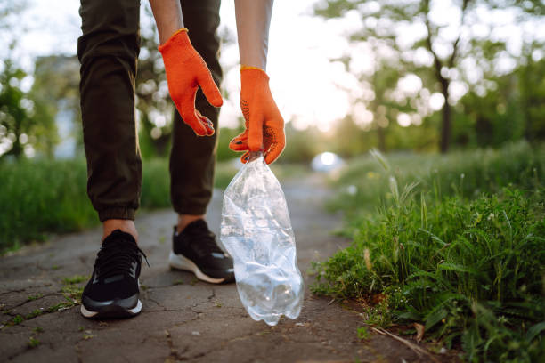 istock Men hand collects plastic trash for cleaning in the park. 1243696146