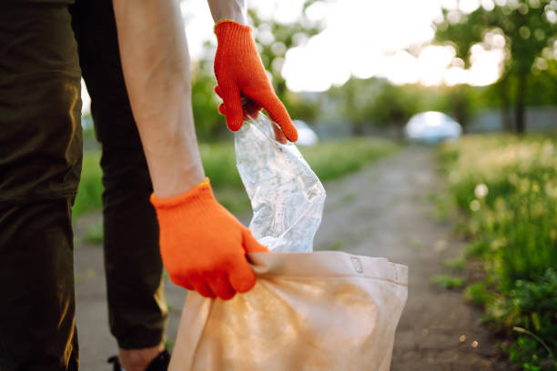 istock Men hand collects plastic trash for cleaning in the park. 1243696149