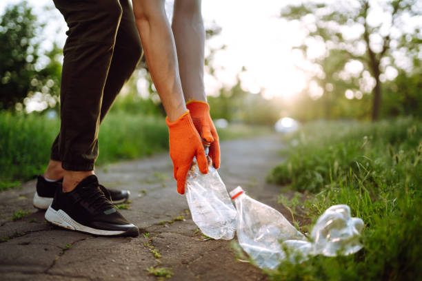 istock Men hand collects plastic trash for cleaning in the park. 1243696654