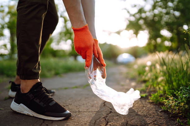 istock Men hand collects plastic trash for cleaning in the park. 1243697722