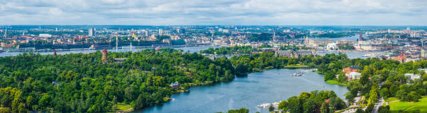 Stockholm aerial panorama over green central cityscape blue fjords Sweden Aerial panorama over the island waterfront of Stockholm, Sweden's vibrant capital city. kungsholmen town hall photos stock pictures, royalty-free photos & images