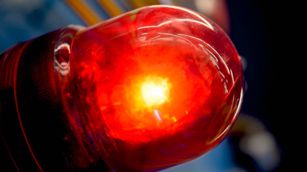 istock Closeup image of glowing red fire alarm light installed in modern building 1243700464