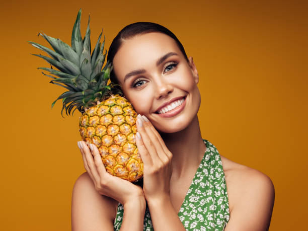 istock Beautiful girl with pineapple 1243729054