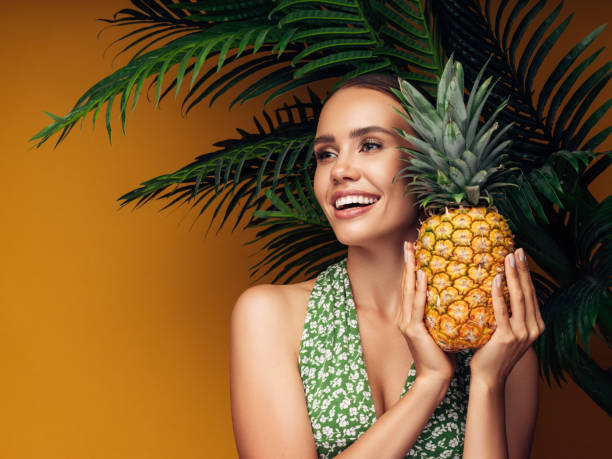 istock Beautiful girl with pineapple 1243729593