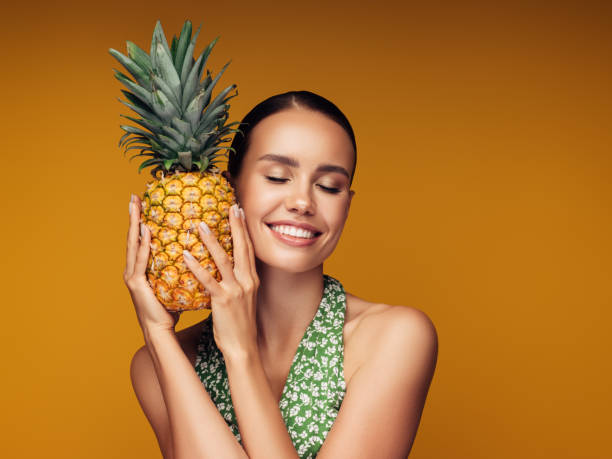 istock Beautiful girl with pineapple 1243729638