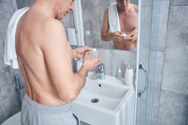 istock Man examining a bottle of liquid in his hands 1243729686