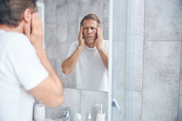 istock Mature short-haired man having a severe headache 1243730190