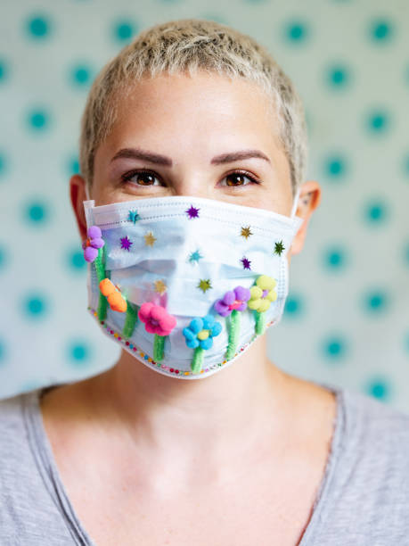 istock Young woman with artsy face mask 1243734480