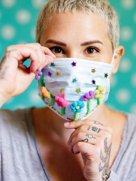 istock Young woman with artsy face mask 1243737120