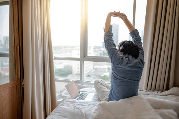 istock Businessman working with laptop on the bed 1243737665