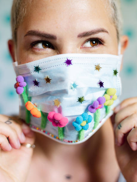 istock Young woman with artsy face mask 1243739253