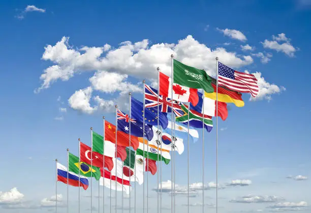 Waving flags countries of members Group of Twenty. Big G20 21â22 November 2020 in the capital city of Riyadh, Saudi Arabia. Blue sky background. 3d rendering.  Illustration.
