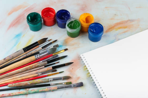 istock art background with paint brushes and color paints 1243764342
