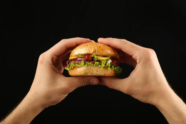 istock hands holding classic american burger 1243766309