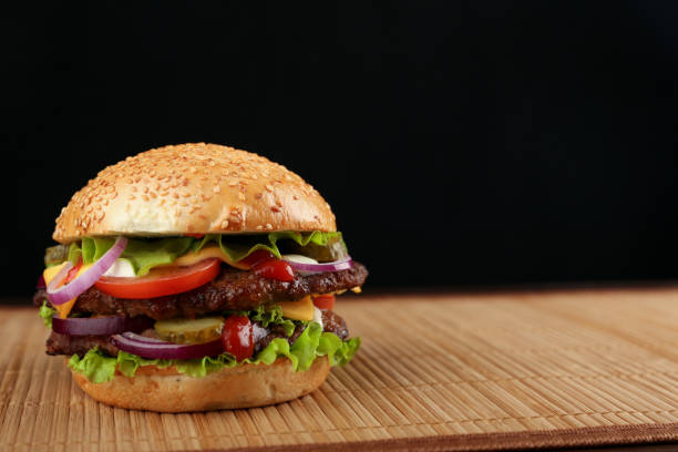 istock classic american burger on dark background 1243766583