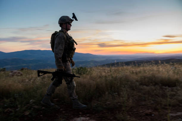 istock Army Soldier walking in battlafield at sunset 1243769892