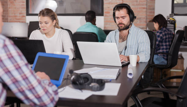 istock Man in headphones working on laptop 1243770988