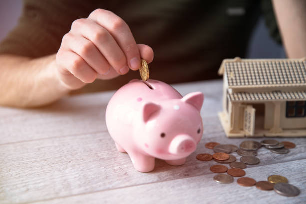 istock man hand coins with piggy bank 1243778134