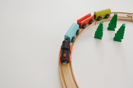 Wooden toy train crossing track bridge. Conceptual