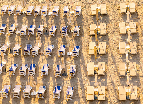 Arranged rows of deckchairs after a day at the beach of the Palm Jumeirah in Dubai