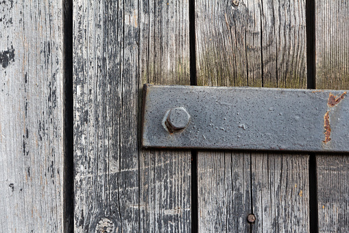 Close-up at closed white wooden house door with chrome door's knob. Selective focus.