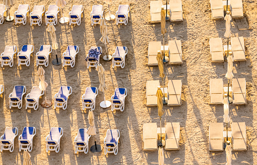 Arranged rows of deckchairs after a day at the beach of the Palm Jumeirah in Dubai