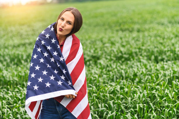 istock Happy girl wrapped herself in a US flag 1243801028