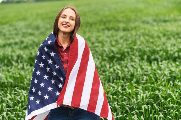 istock Happy girl wrapped herself in a US flag 1243801034