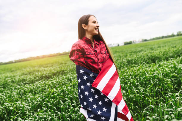 istock Happy girl wrapped herself in a US flag 1243801040