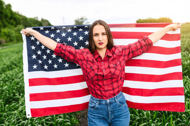 istock Serious young woman with american flag 1243801049