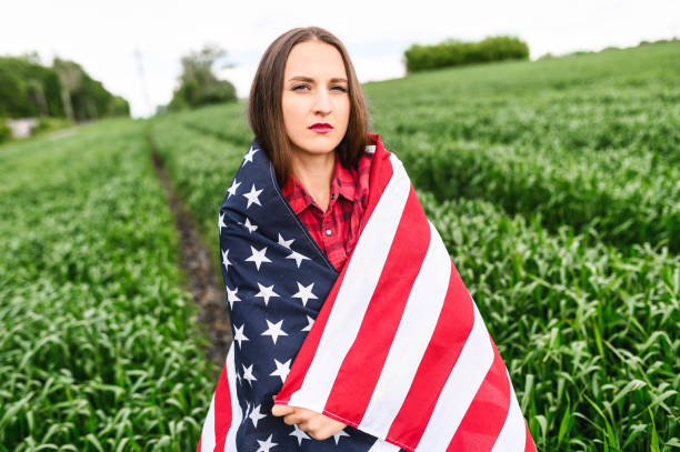 istock Serious young woman with american flag 1243801427