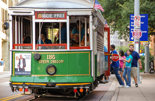 Dallas, Texas - September 2009: Close up view of people boarding a preserved streetcar on the McKinney Avenue trolley system in downtown Dallas. It is also known as the M-Line Trolley and is free to ride.