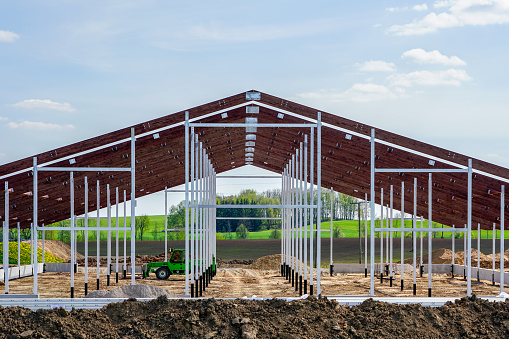 view of a new modern metal frame structure of an agricultural building under construction