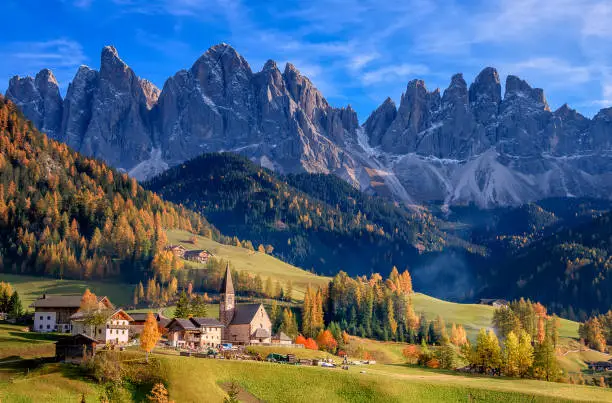 Photo of Golden autumn in Val di Funes valley and chapel Santa Maddalena. Odle mountain group. Dolomite's mountains, Italy
