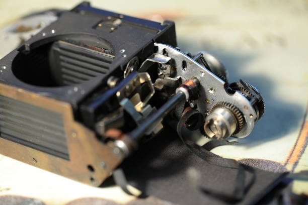 istock Disassembled vintage camera on a white table. Repair an old analog film camera. Selective focus. 1243810293
