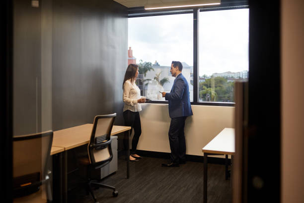 istock Mature Business Colleagues Conversing at Office Window 1243814606