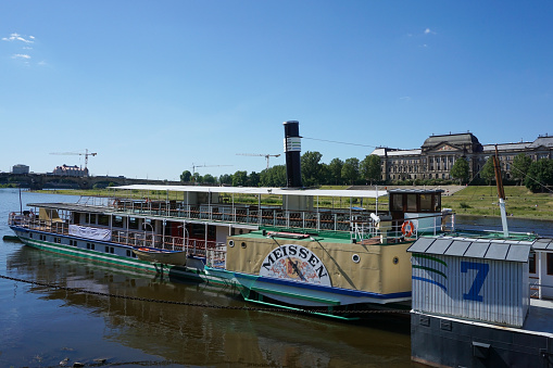 Dresden, Germany - June 01 2020: The paddle steamer PD Meissen of the Sächsische Dampfschiffahrt on the river Elbe in Dresden. Dresden has the oldest fleet of active paddle steamers in the world.
