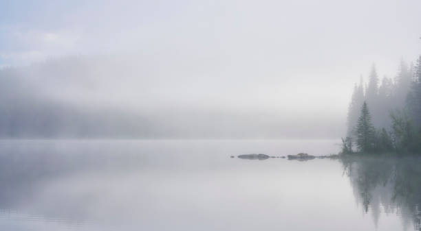 istock Morning fog in Pyramid Lake in Canada 1243820044