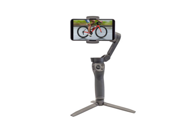 smartphone on a stabilizer with the image of a cyclist on the screen isolated on a white background