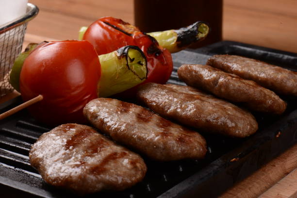 grilled meatball tomatoes and pepper are in the griddle