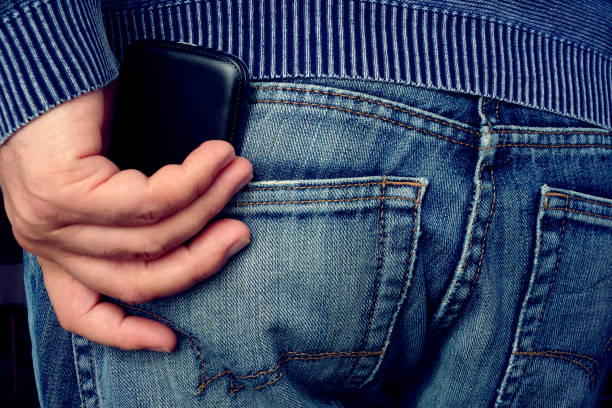 istock Men's hand holding a cell phone 1243838336