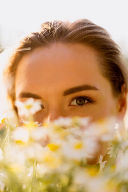 istock Beautiful woman with chamomile flowers 1243841814