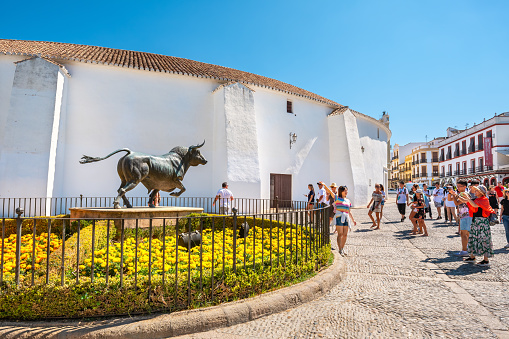 Ronda, Andalusia, Spain - July 17, 2019: Tourist on the Plaza de Toros de Ronda near one of the oldest bullrings in Spain