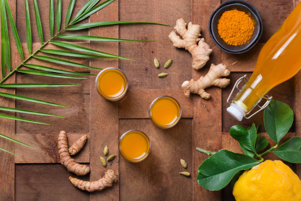 Turmeric ginger drink, immune booster, anti inflammatory beverage Healthy immune system booster, cold and flu remedy. Turmeric ginger lemon beverage, anti inflammatory smoothie, autumn and winter drink. Detox, clean eating, dieting concept. ginger health stock pictures, royalty-free photos & images