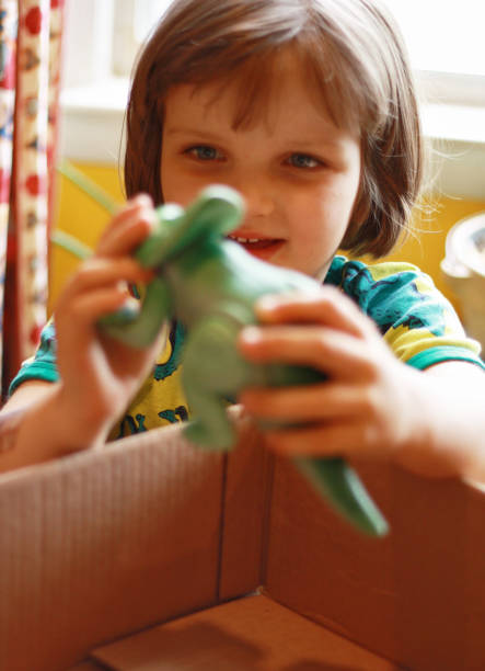 istock A little girl get her dinosaur through online order. 1243848165