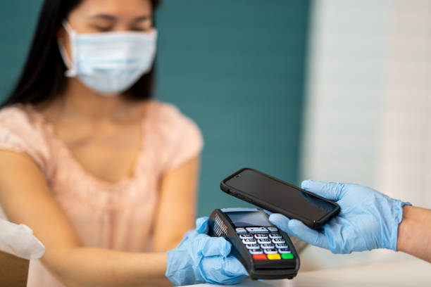 istock Business owner doing a contactless transaction at her shop 1243863005